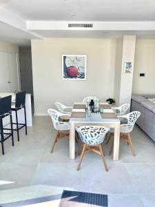 a dining room with a table and chairs at Luxury Penthouse Jacobo - The View Fuengirola in Fuengirola