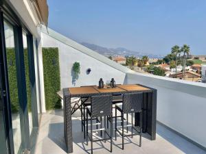 a table and chairs on the balcony of a house at Luxury Penthouse Jacobo - The View Fuengirola in Fuengirola
