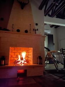 a brick fireplace with a fire in it at Sochi Paradise in Sochi