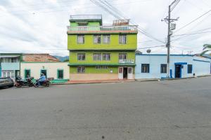 a yellow building on the side of a street at Ayenda Danilo in Ibagué