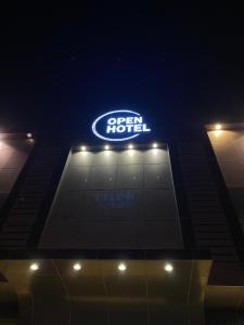 a sign on top of a hotel at night at Open Hotel in Riyadh