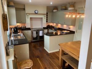 a kitchen with white cabinets and a wooden floor at Beautiful 5 Bedroom, Amazing Water & Valley Views in Dartmouth