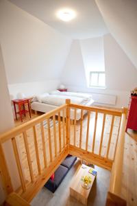 a room with a bed and a wooden staircase at Gutshaus Ketelshagen in Putbus