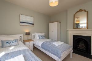 a bedroom with two beds and a fireplace at Crossgate in Durham