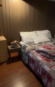 a bed in a room with a table next to it at Appartamento Francesca in Marilleva +2 photos