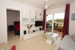 a living room with a couch and a table at Voramar 26b in Calpe