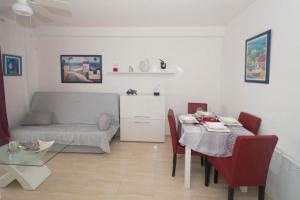 a living room with a table and a couch at Voramar 26b in Calpe