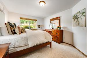 a bedroom with a bed and a dresser and a window at La Via Bella Retreat by the Lake in Manson +45 photos