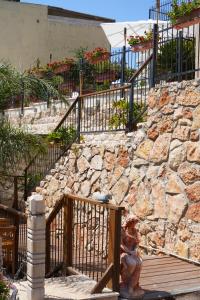 a stone retaining wall with stairs and a statue at Abu Hanna Boutique by Ahlan Hospitality in Nazareth