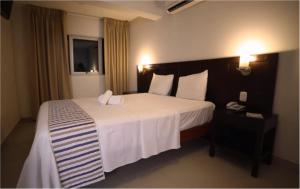 a bedroom with a large white bed in a room at Hotel Boulevard Plaza in Pucallpa