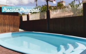 una piscina frente a una valla en HANNA Flat Amsterdam en Florianópolis