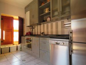a kitchen with stainless steel appliances and a window at Casa do Sol in Arouca
