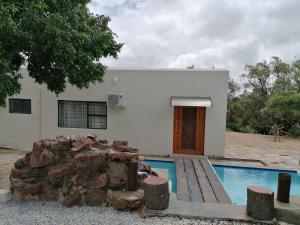 a house with a swimming pool in front of it at JB Countrylife Accommodation in Centurion