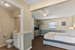a bedroom with a bed and a toilet and a television at Granada Ocean Resort in Wildwood Crest +86 photos