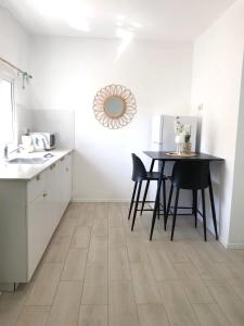 a kitchen with a table and chairs in a room at Oria studio's in Eilat