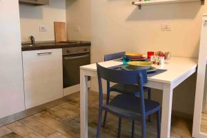uma pequena cozinha com uma mesa e duas cadeiras em BGY Airport - La Cascinetta em Grassobbio
