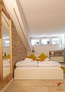 a bed in a room with a brick wall at Apartments Opa Opa in Rijeka