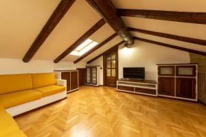 a living room with a couch and a television at La Morra Flats in La Morra