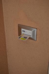 a safe on a wall with a sticker on it at Hotel Europa in Nereto