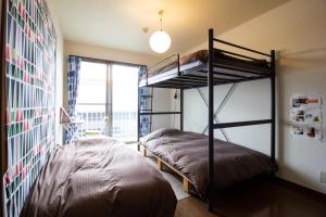 Postel nebo postele na pokoji v ubytování ゲストハウスTSUU小田原 Guest House Tsuu Odawara #OD1