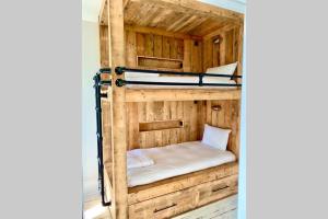 a bunk bed in a room with wooden walls at Cleveland House - Perfect for Beaches and Town. in Bournemouth