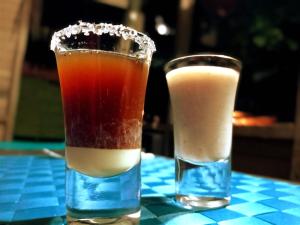 two glasses of drinks sitting on a table at Lodge El Amargal - Reserva Natural, Ecoturismo & Surf in Nuquí