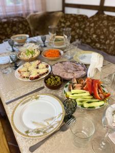 a table with plates of food on top of it at Karpatska Mria in Yaremche