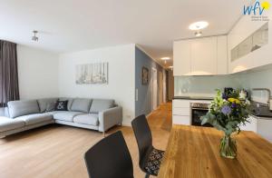 a living room with a couch and a table at Haus Talita - Wohnung TANGO in Juist