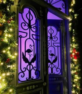 a purple glass window with a christmas tree in the background at Konjelazia - Tourism & Design in Gyumri