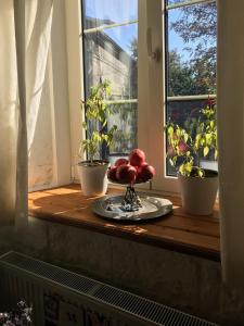 a window sill with a plate of fruit on a table at Konjelazia - Tourism & Design in Gyumri