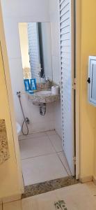 a bathroom with a sink and a mirror at Motel& Hotel Apê Goiânia !!! in Goiânia