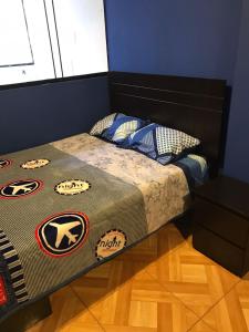 a bedroom with a bed with a superman blanket at 300 Departamento Centrico distrito de chorrillos in Lima