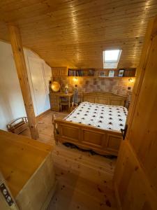 a bedroom with a large bed in a wooden room at Музикалната къща in Breze