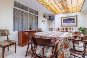 a dining room with a table and chairs at Ayenda Casa Hostal del Norte in Bogotá