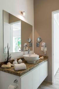 a bathroom with a sink and a large mirror at Villa Calma, Chic & Mexican Villa, a True Oasis Pool, Security in Tulum
