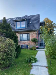 a brick house with a window on top of it at Altes Siedlerhaus Nesebanz in Gustow