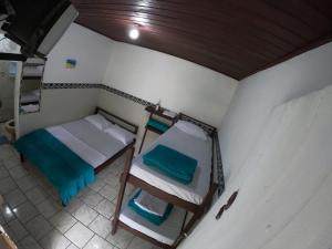 a small room with two bunk beds in it at Pousada Recanto da Gruta in Ilha do Mel