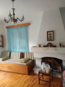 a living room with a couch and a fireplace at Aetofolia Melissourgoi in Melissourgoi