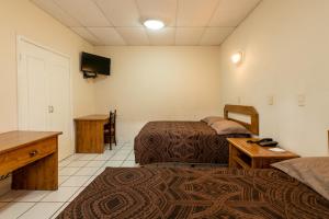 Ένα ή περισσότερα κρεβάτια σε δωμάτιο στο Hotel Sntenario