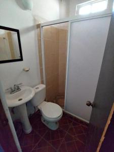 a bathroom with a toilet and a sink and a shower at CASA NANTLI in Yelapa