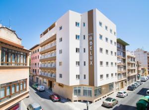 a tall white building on a city street at Abelux in Palma de Mallorca
