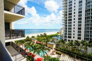 a view of the beach from the balcony of a building at Palm Beach Singer Island Resort & Spa Luxury Suites in Riviera Beach
