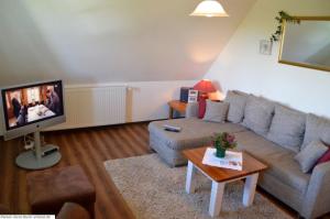a living room with a couch and a tv at Luv - a05408 in Dunsum