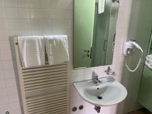 y baño con lavabo, espejo y toallas. en Locanda del Tavolo Matto, en Potenza Picena