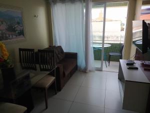 a living room with a couch and a table at Apt 219 in João Pessoa