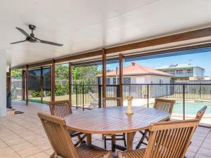 a wooden table and chairs on a patio at 31 Beech Street in Evans Head