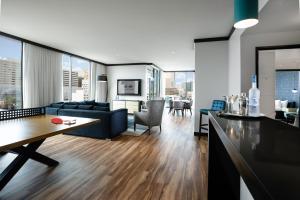 a living room with a blue couch and a table at Downtown Grand Hotel & Casino in Las Vegas