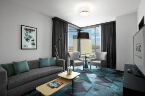 a living room with a couch and a table at Downtown Grand Hotel & Casino in Las Vegas