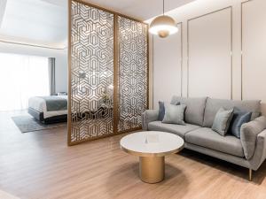 a living room with a couch and a table at Resorts World Sentosa - Crockfords Tower in Singapore