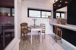a kitchen with a white table and chairs at K2 Residence in Campinas